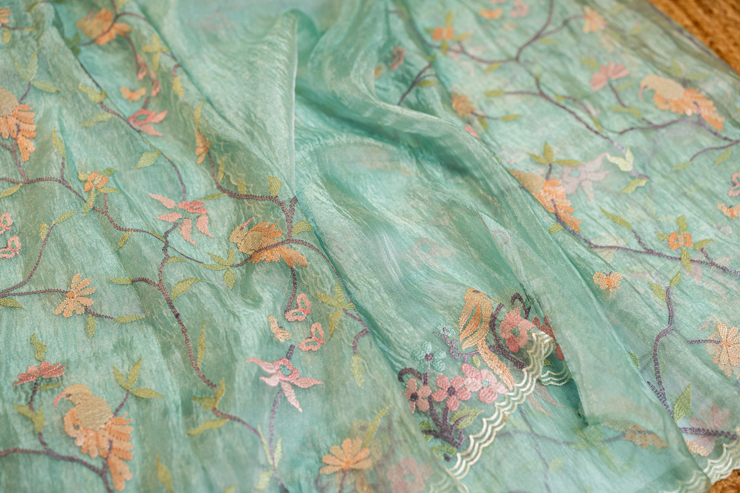 Glass Tissue saree with floral and nature-inspired motifs embroidery