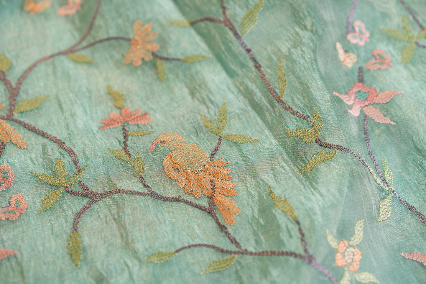 Glass Tissue saree with floral and nature-inspired motifs embroidery